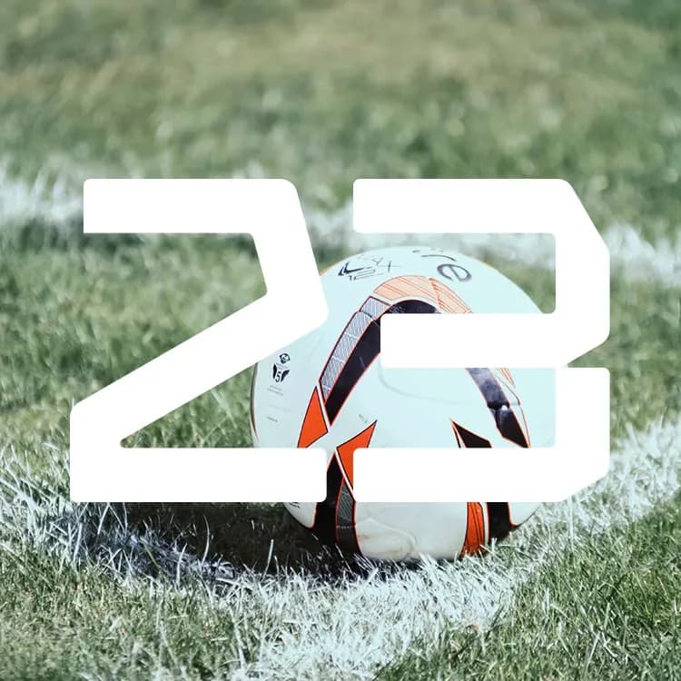 Soccer ball on a grassy field with white lines, overlaid by the number "23" in bold white.