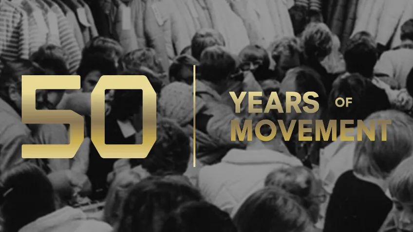 Black and white photo of a crowded gathering with text overlay: "50 Years of Movement" in gold.